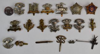 Approximately twenty British Army cap badges comprising Royal Irish Regiment, Royal Irish Fusiliers,