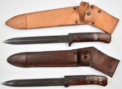 Two Czechoslovakia 1958 pattern bayonets with wood chip grips, 17cm fullered blades and scabbards.