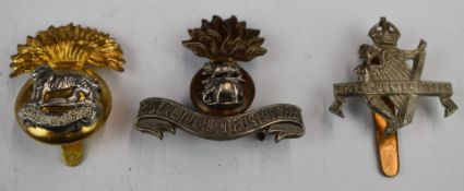 Three British Army cap badges comprising Royal Munster Rifles (J R Grant to slider), Royal Dublin