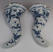 A pair of Worcester first period blue and white cornucopia wall pockets of spiral moulded form,