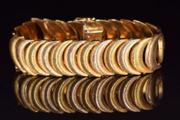 An 18k gold bracelet made up of crescent shaped textured links, 44.4g