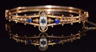 Edwardian 9ct gold bangle set with a sapphire, paste and seed pearls with rope twist and sphere