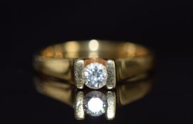 An 18ct gold ring set with a round cut diamond of approximately 0.24ct, 4.6g, size L