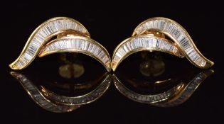 A pair of 18ct gold earrings set with baguette cut diamonds, 4.9g