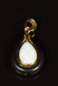 A 9ct gold pendant set with a pear cut opal set into the matrix, 0.8g