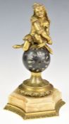 Novelty table clock formed as a jester atop a globe, with gilt metal and marble mounts, height 21.
