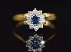 An 18ct gold ring set with a sapphire surrounded by diamonds, 2.7g, size M
