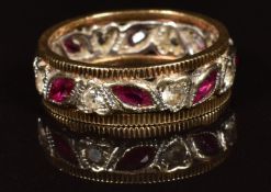 A 9ct gold eternity ring set with marquise cut rubies and spinel, 3.3g
