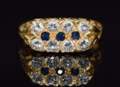 An 18ct gold ring set with three sapphires and two rows of diamonds, 5.3g, size M