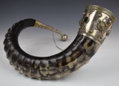 A large curved horn drinking vessel, the silver plated and gilt mounts set with agate cabochons