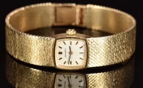 Zenith 9ct gold ladies wristwatch with black hands, two-tone hour markers, silver dial, and signed