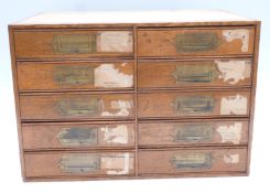 Oak haberdashery jewellery shop cabinet of ten drawers with campaign style handles, some with
