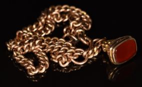 A 9ct rose gold double Albert / watch chain and a 9ct gold fob set with carnelian agate, c1900,