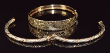 A 9ct gold bangle with cut out floral decoration and a 9ct bi-coloured bangle, 18.6g