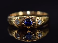 An 18ct gold ring set with a sapphire and diamonds in star settings, Chester 1906, 4.7g, size M