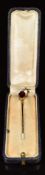 Victorian stick pin set with an oval cut garnet with foliate decoration (2.2g), in vintage box