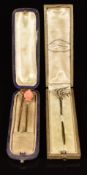 Three Victorian / Edwardian stick pins set with coral and seed pearls, in two vintage boxes