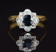 An 18ct gold ring set with a sapphire surrounded by diamonds, 3.5g, size M