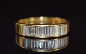 An 18ct gold ring set with nine baguette cut diamonds, each approximately 0.1ct, 3.6g, size O