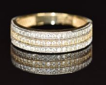 A 14k gold ring set with three rows of diamonds in a bi-coloured setting, 2.5g, size N