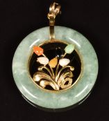 Jadeite and 14k gold pendant with floral sprig to the centre set with jadeite cabochons, diameter