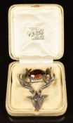 A silver brooch in the form of a stag, set with quartz