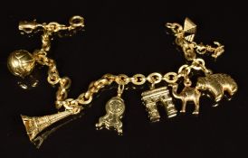 An 18ct gold charm bracelet with thirteen 18ct gold charms including football, clock, Eiffel