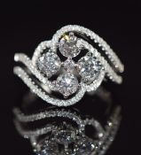 An 18ct white gold ring set with four diamonds of approximately 1.38ct and a further 79 totalling