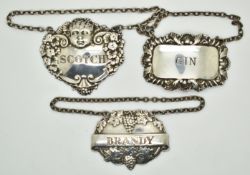 Three late 20thC hallmarked silver bottle tickets comprising gin, scotch and brandy, weight 43g