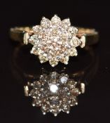 A 9ct gold ring set with champagne diamonds in a cluster, 2.1g, size J
