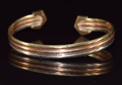 A 9ct gold tri-coloured bangle, 9.5g