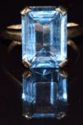 A 9ct gold ring set with an emerald cut blue topaz, 5.9g, size I