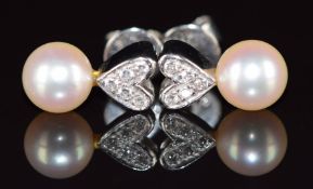 A pair of 18k white gold earrings, each set with a pearl and diamonds in a heart setting, 2.8g