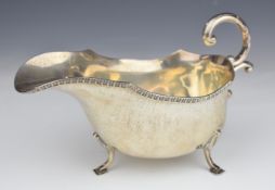 George VI hallmarked silver sauce boat raised on three feet, Birmingham 1935, maker A E Poston &