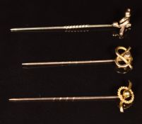 Two Edwardian 9ct gold stick pins in knot and sphere decoration (2.1g) and a similar yellow metal