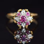 An 18ct gold ring set with rubies and diamonds in a cluster, 4.4g, size O