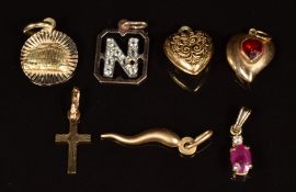 Six 9ct gold pendants including ruby and diamond, hearts, cross and letter N (2.4g) and 14k gold