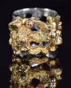 A 1970s 18ct tri-coloured gold ring with textured and abstract design, London 1971, maker SGC, 23.
