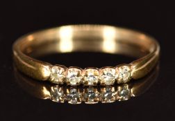 A 9ct gold ring set with five diamonds, 0.9g, size L