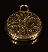 A 9ct gold locket with scrolling decoration, 7.7g