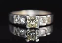 A 14ct gold ring set with a princess cut diamond of approximately 0.6ct and four further princess