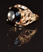A 14k gold ring set with a round cut smoky quartz, 8.0g, size R