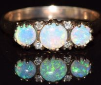 A 9ct gold ring set with three opals and diamonds, 2.1g, size N