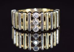 A 14ct gold bi-coloured ring set with three diamonds, 9.7g, size T