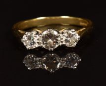 An 18ct gold ring set with three diamonds totalling approximately 0.65ct, in antique box