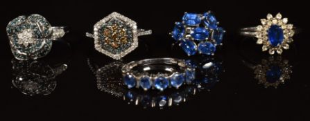 Five silver rings set with diamonds and sapphires