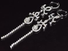 A pair of 18ct white gold earrings set with a diamond of approximately 0.4ct and a quantity of