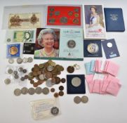 A tin containing a collection of various coins and coin sets, small silver content, George V £1 note