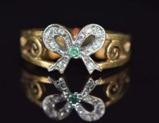 A 9ct gold ring in the form of a bow set with paste and emerald, 2.2g, size P/Q