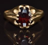 A 9ct gold ring set with an oval cut garnet, 2.2g, size R
